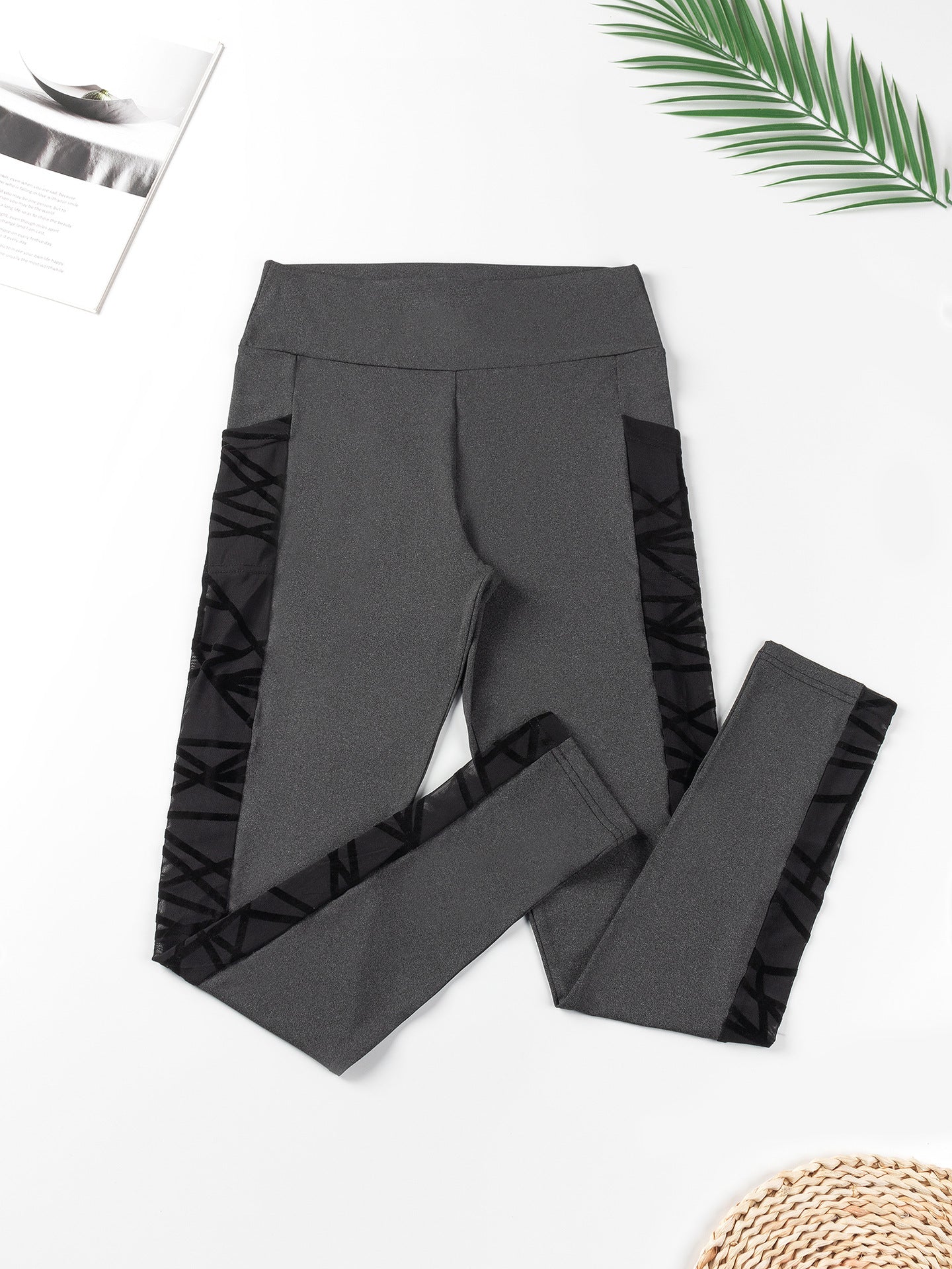 Gray leggings with ruffle details on a white background