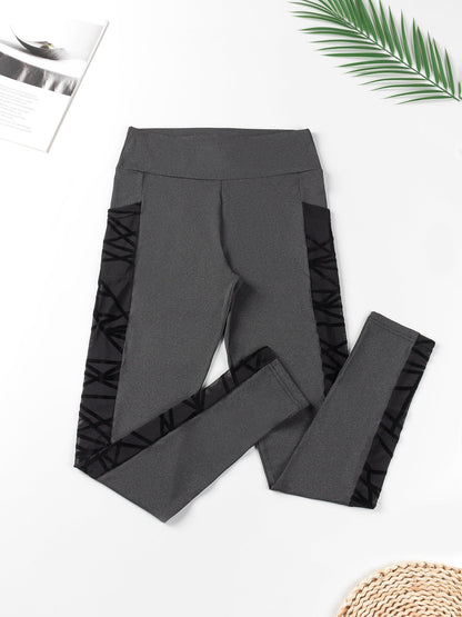 Gray leggings with ruffle details on a white background