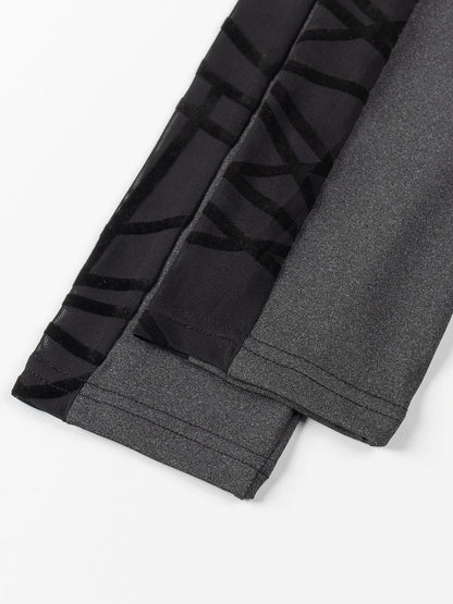 Gray leggings with black striped pattern on a white background