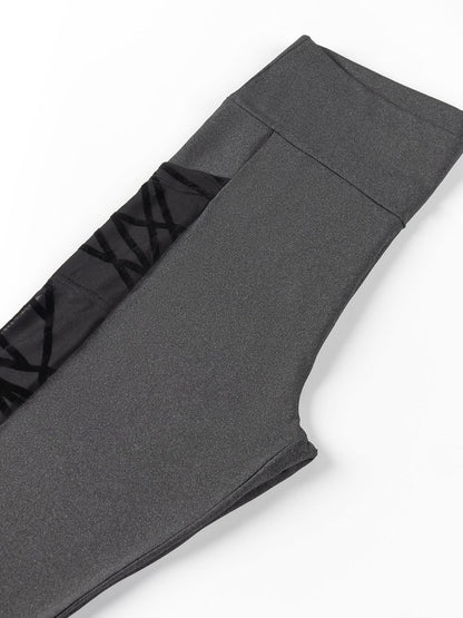 Gray leggings with black waistband on a white background