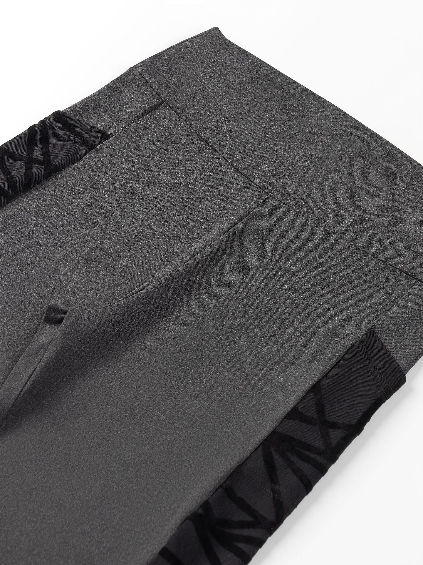 Close-up of gray pants with a white background