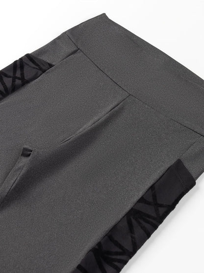 Close-up of gray pants with a white background