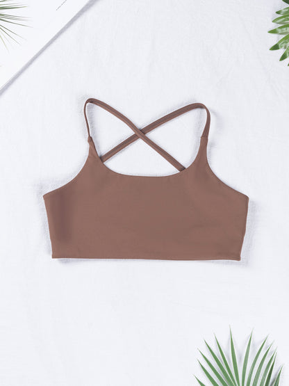 Brown crop top with criss-cross straps on a white background