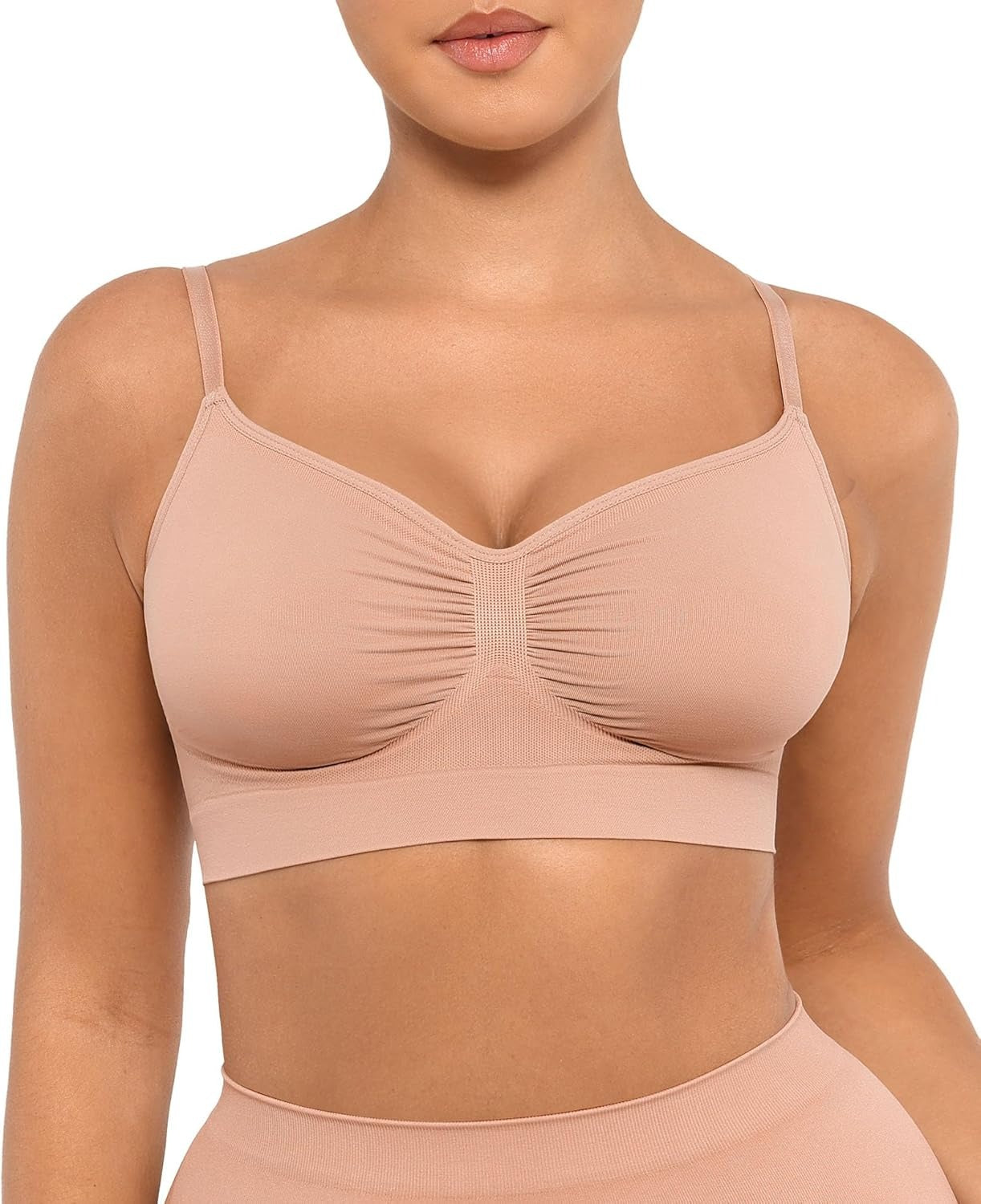 Beige sports bra worn by a model on a white background