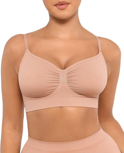 Beige sports bra worn by a model on a white background