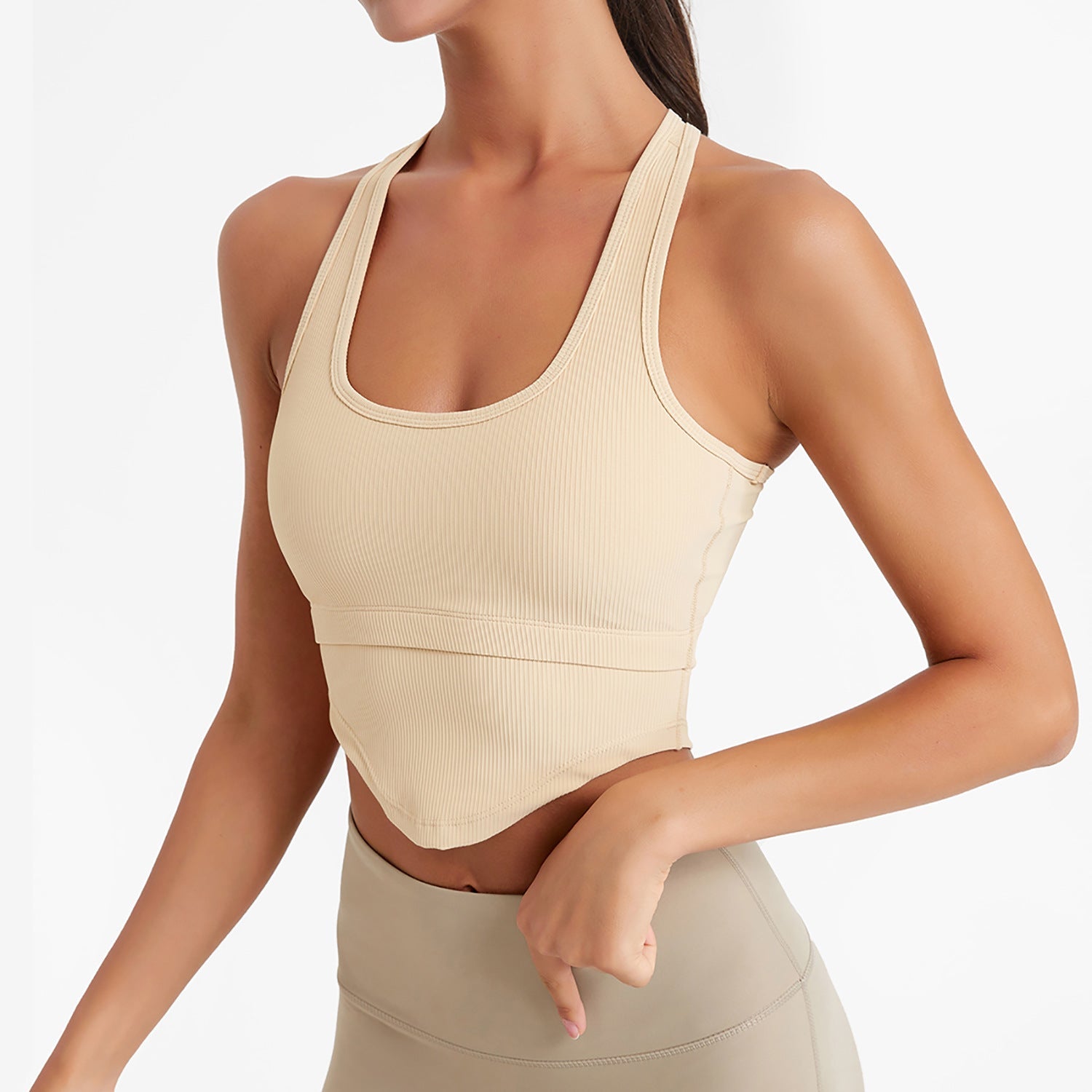 Beige sports bra and leggings on a plain background
