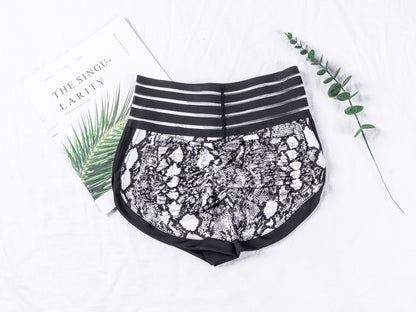 Black lace shorts with striped waistband on a white background