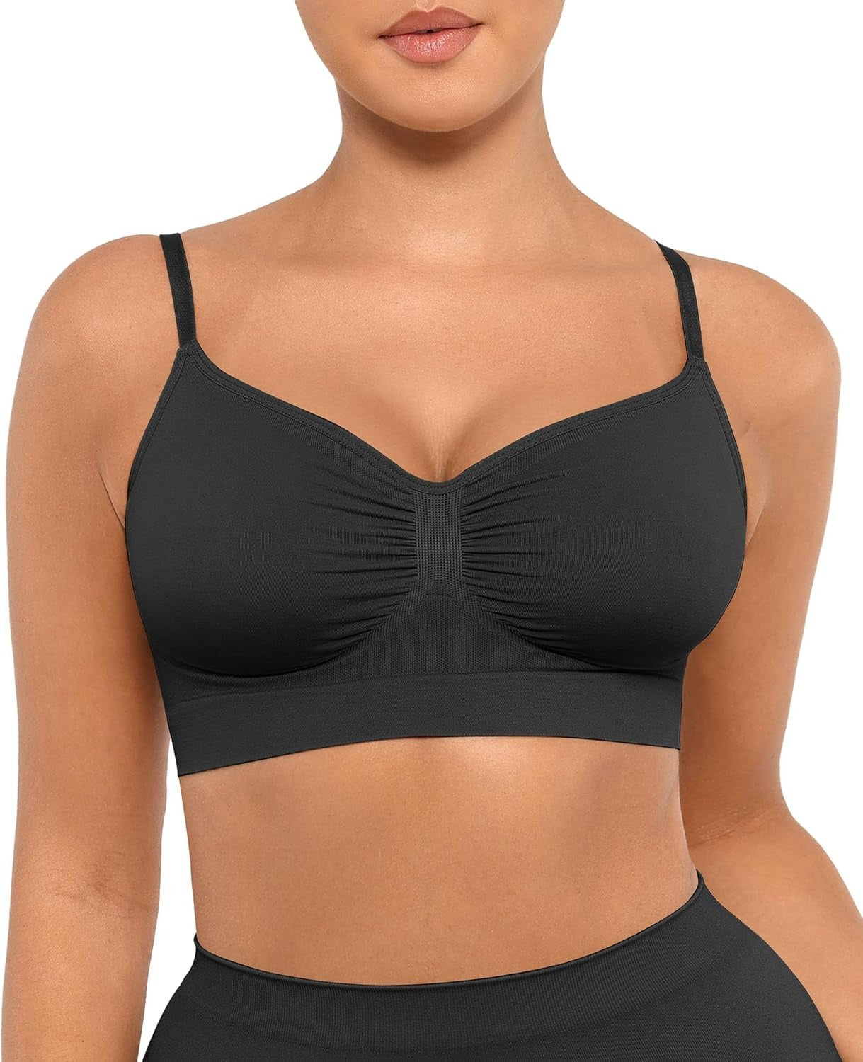 Black sports bra worn by a person on a white background
