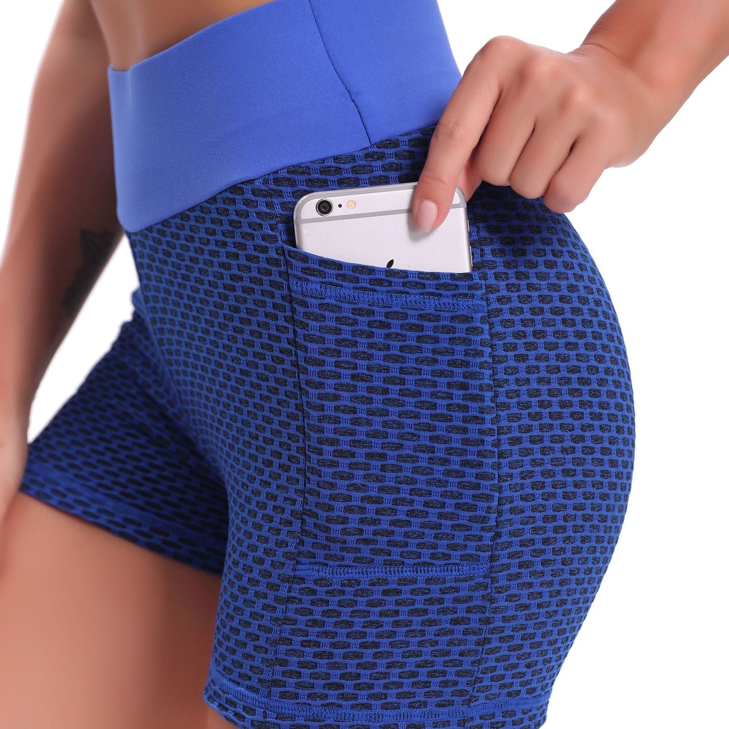 Blue patterned shorts with a pocket holding a phone on a white background