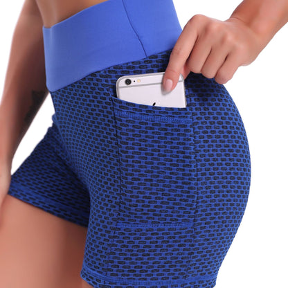 Blue patterned shorts with a pocket holding a phone on a white background