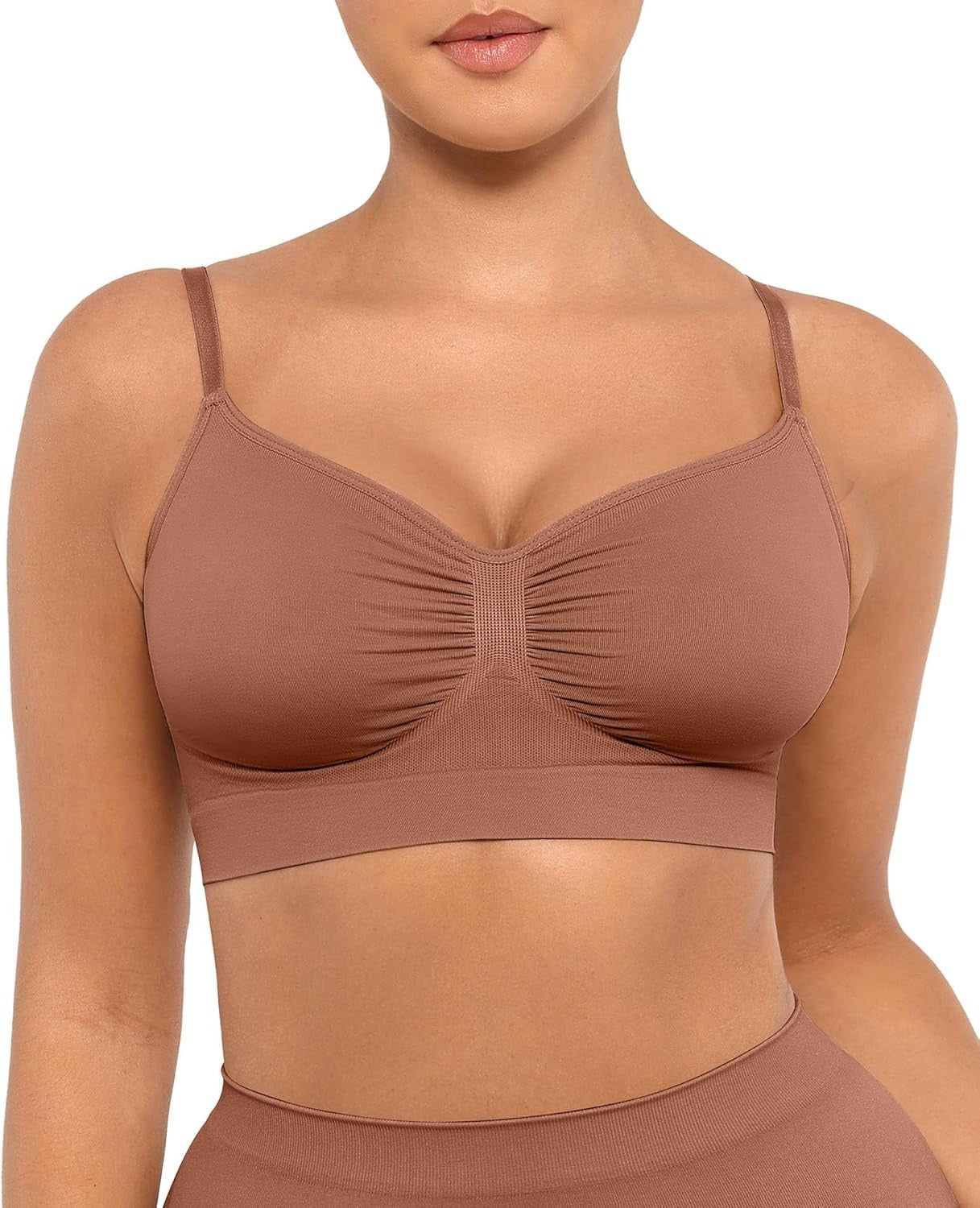 Brown sports bra worn by a model on a white background