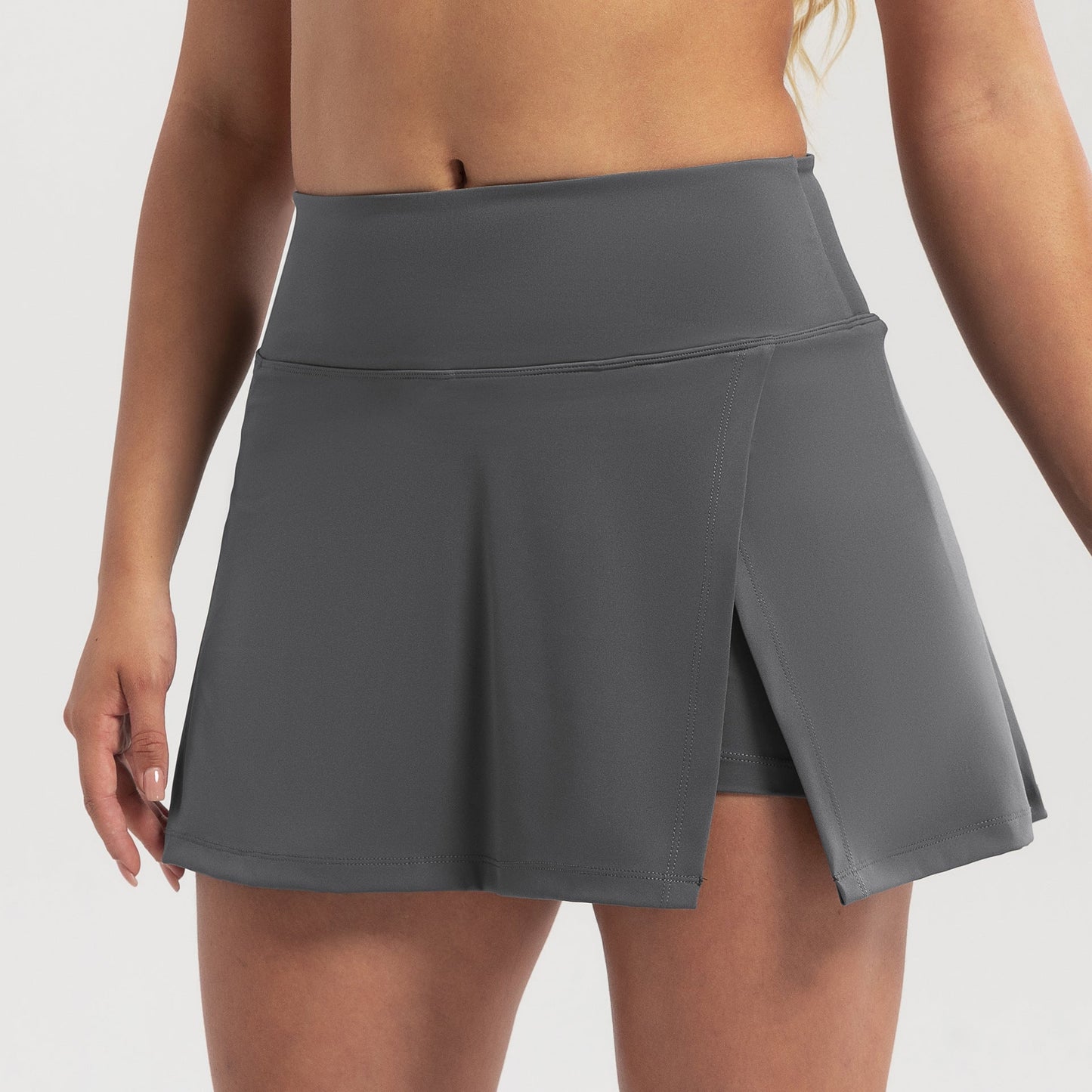 Gray skirt worn by a person on a white background