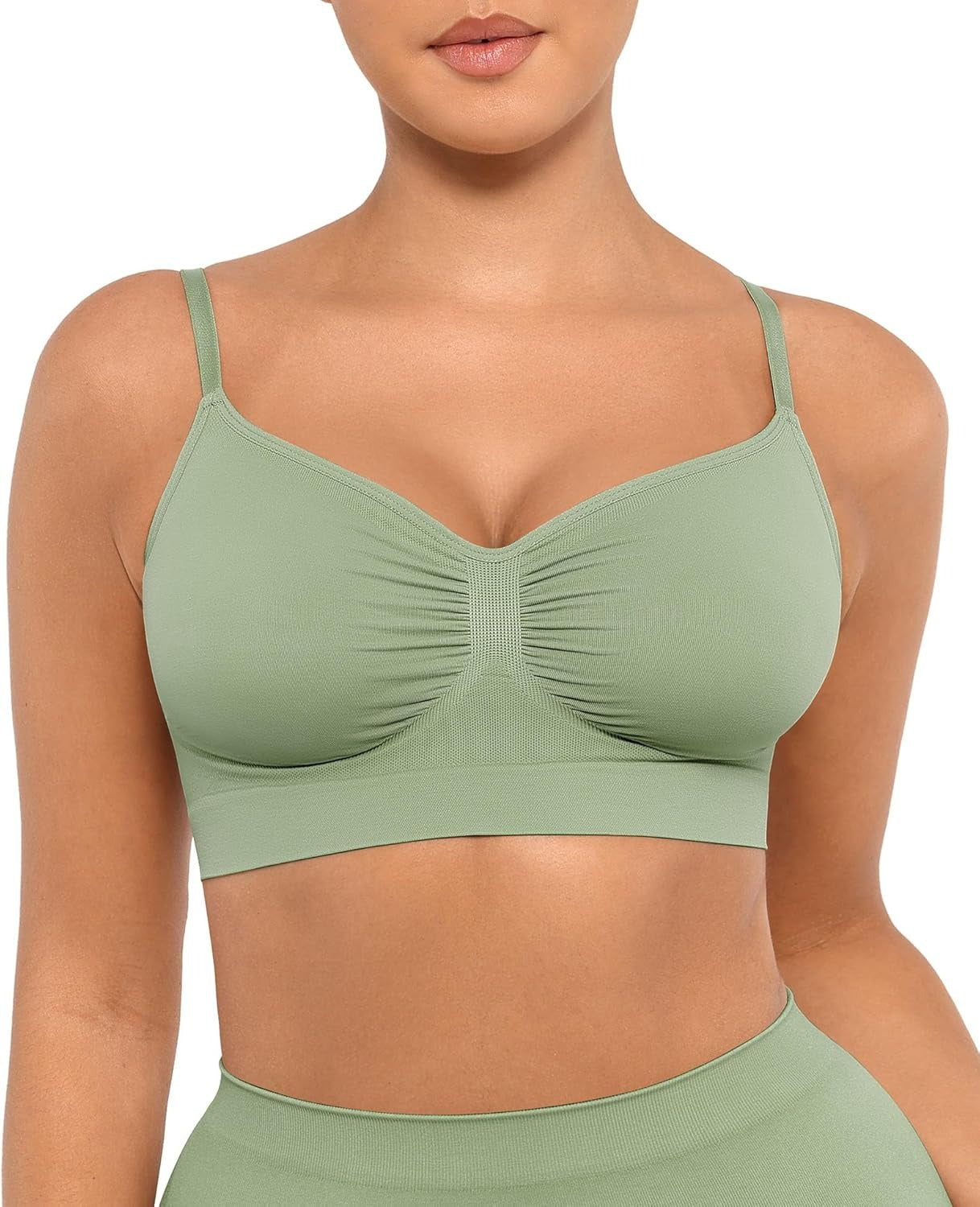 Green sports bra worn by a person on a white background
