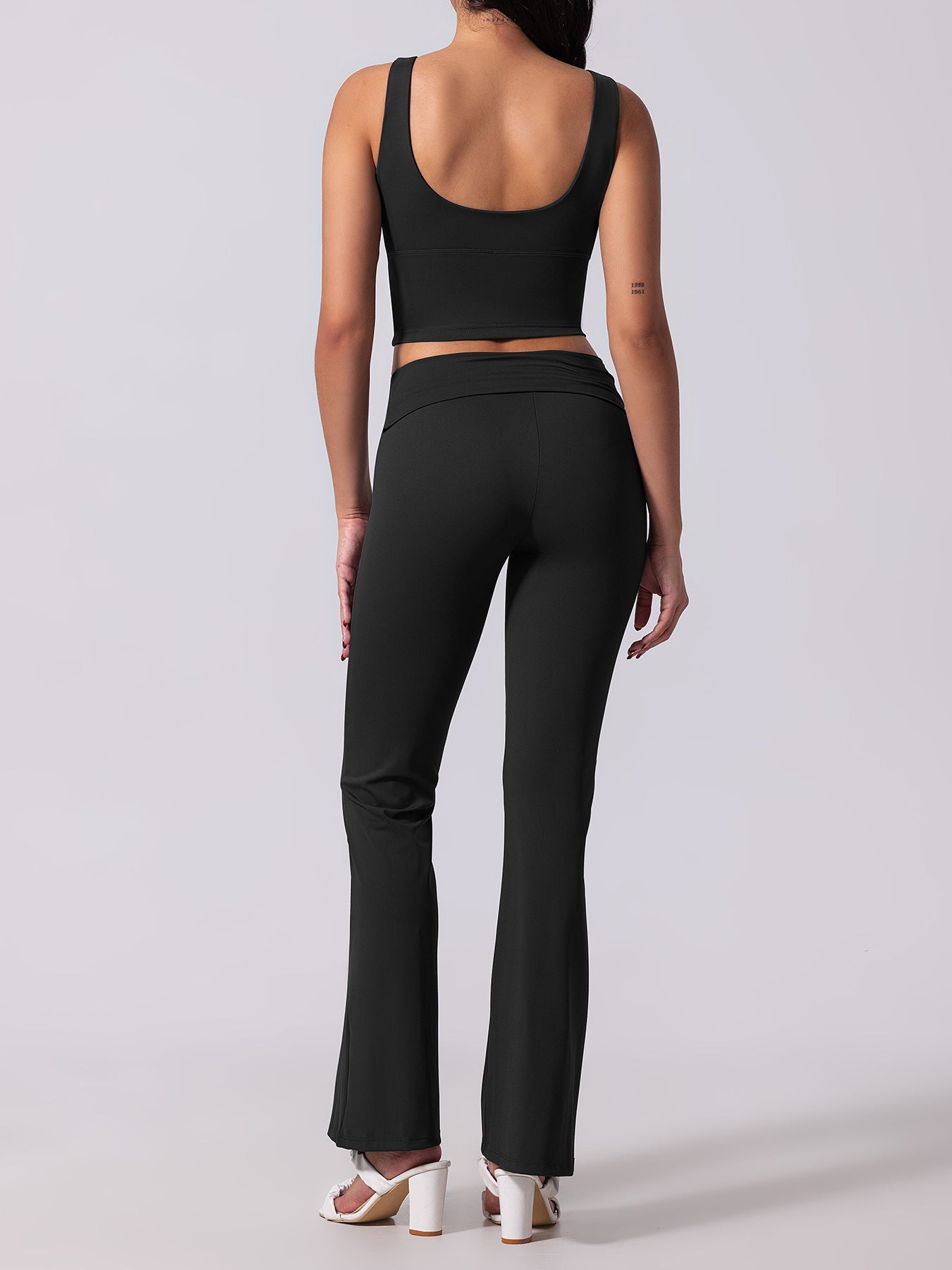 Person wearing a black athletic outfit on a white background