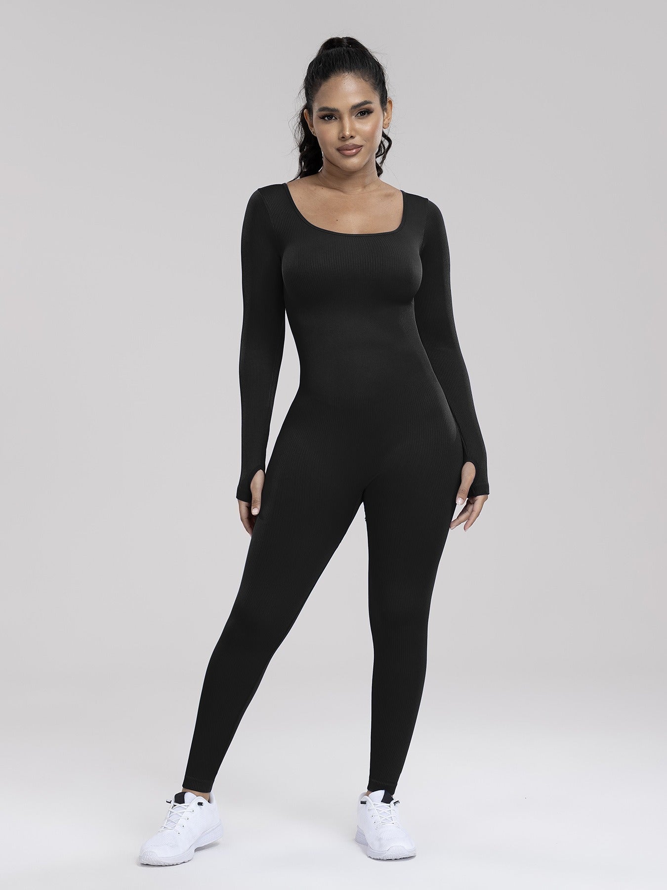 Person wearing a black bodysuit on a white background