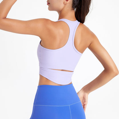 Person wearing a light purple sports bra and blue leggings on a white background