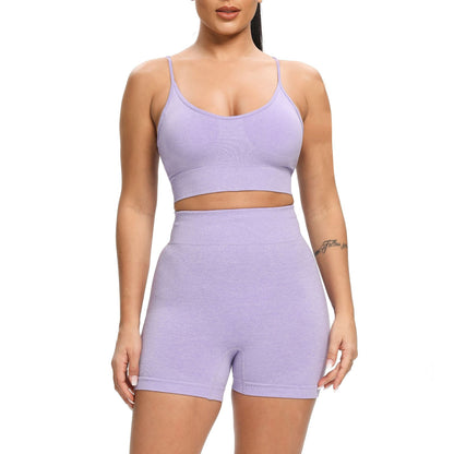 Person wearing a matching lavender sports bra and high-waisted shorts on a white background