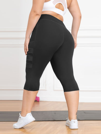 Person wearing black capri leggings with a white background