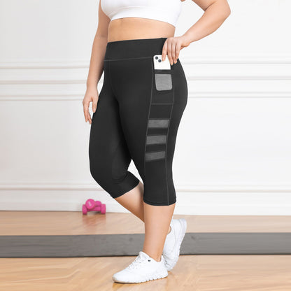 Person wearing black leggings with pocket details on a light wooden floor.