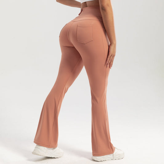 Person wearing peach-colored flared pants on a white background