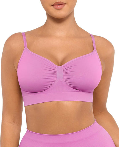 Pink sports bra worn by a person on a white background