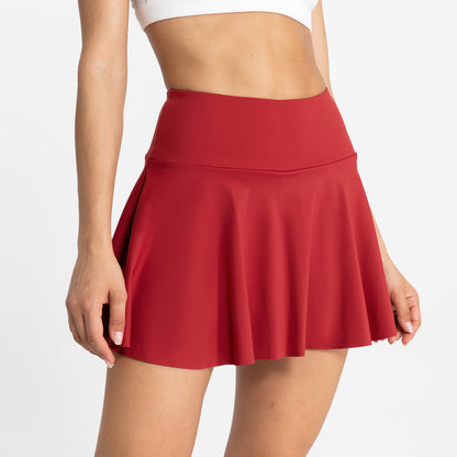 Red skirt worn by a person on a white background