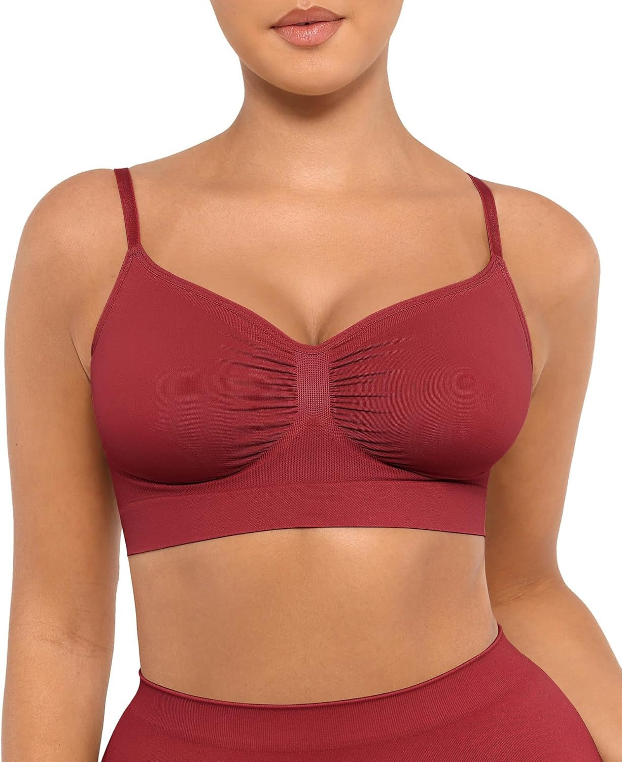 Red sports bra worn by a person on a white background