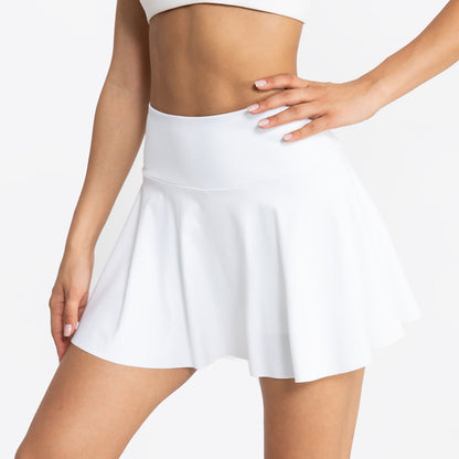 White tennis skirt worn by a person on a plain background