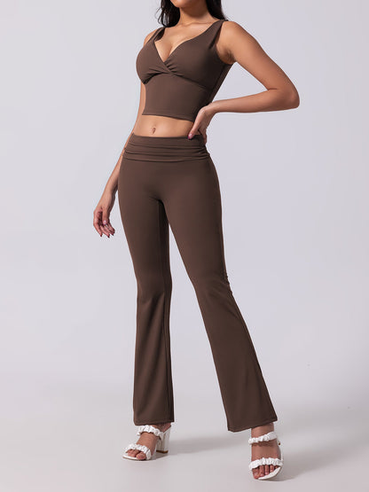 Woman wearing a brown outfit with a top and flared pants on a white background