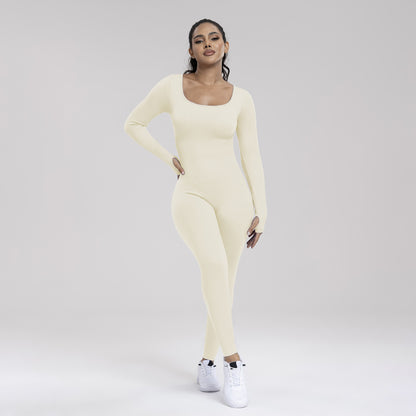 Woman wearing a light yellow long-sleeve top and leggings set on a plain background