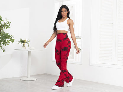 Woman wearing a white crop top and red patterned pants in a minimalistic room.