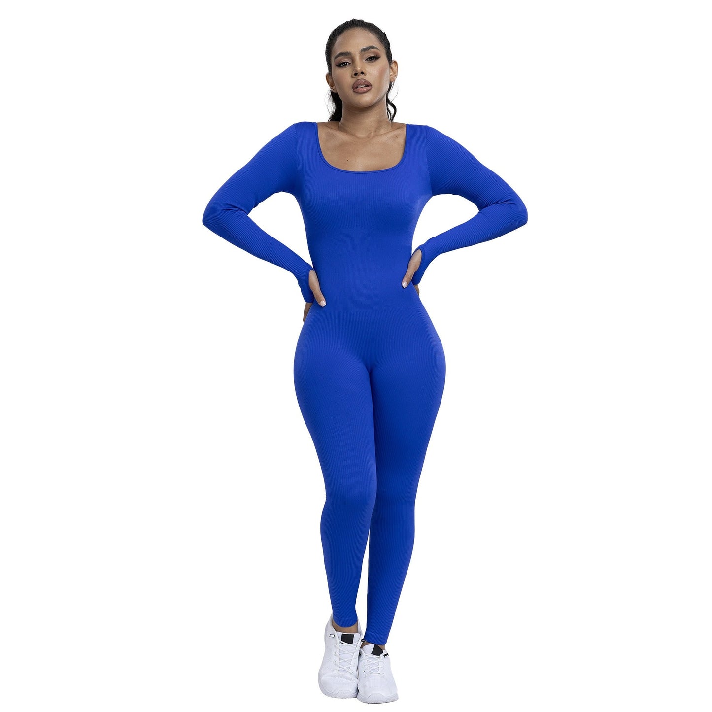 Woman wearing a blue jumpsuit on a white background