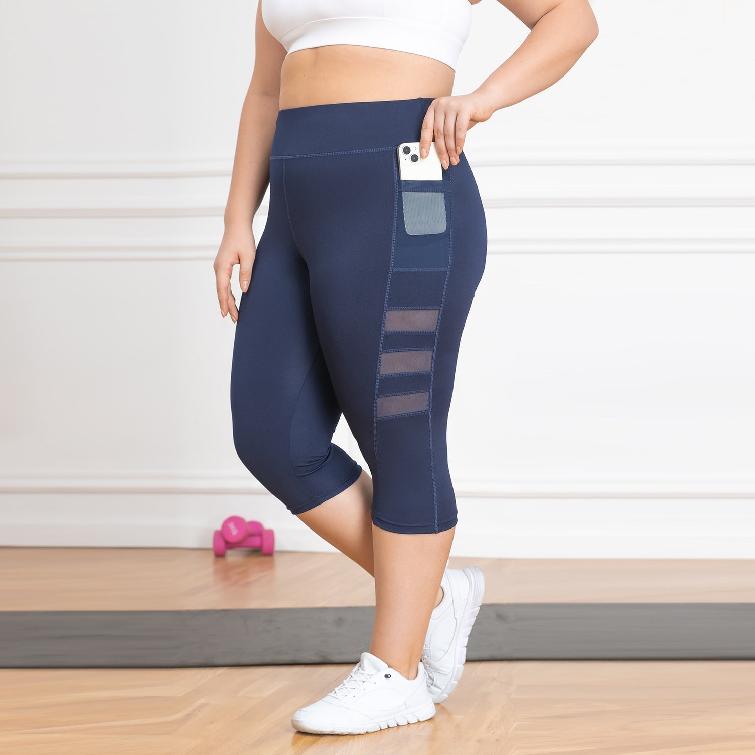 c with mesh panels, standing on a wooden floor.