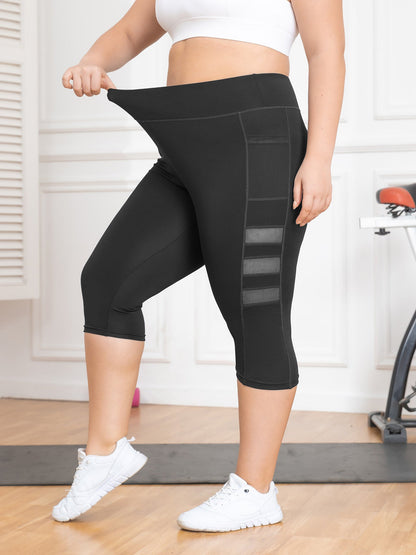 Person wearing black capri leggings with mesh panels in a home setting